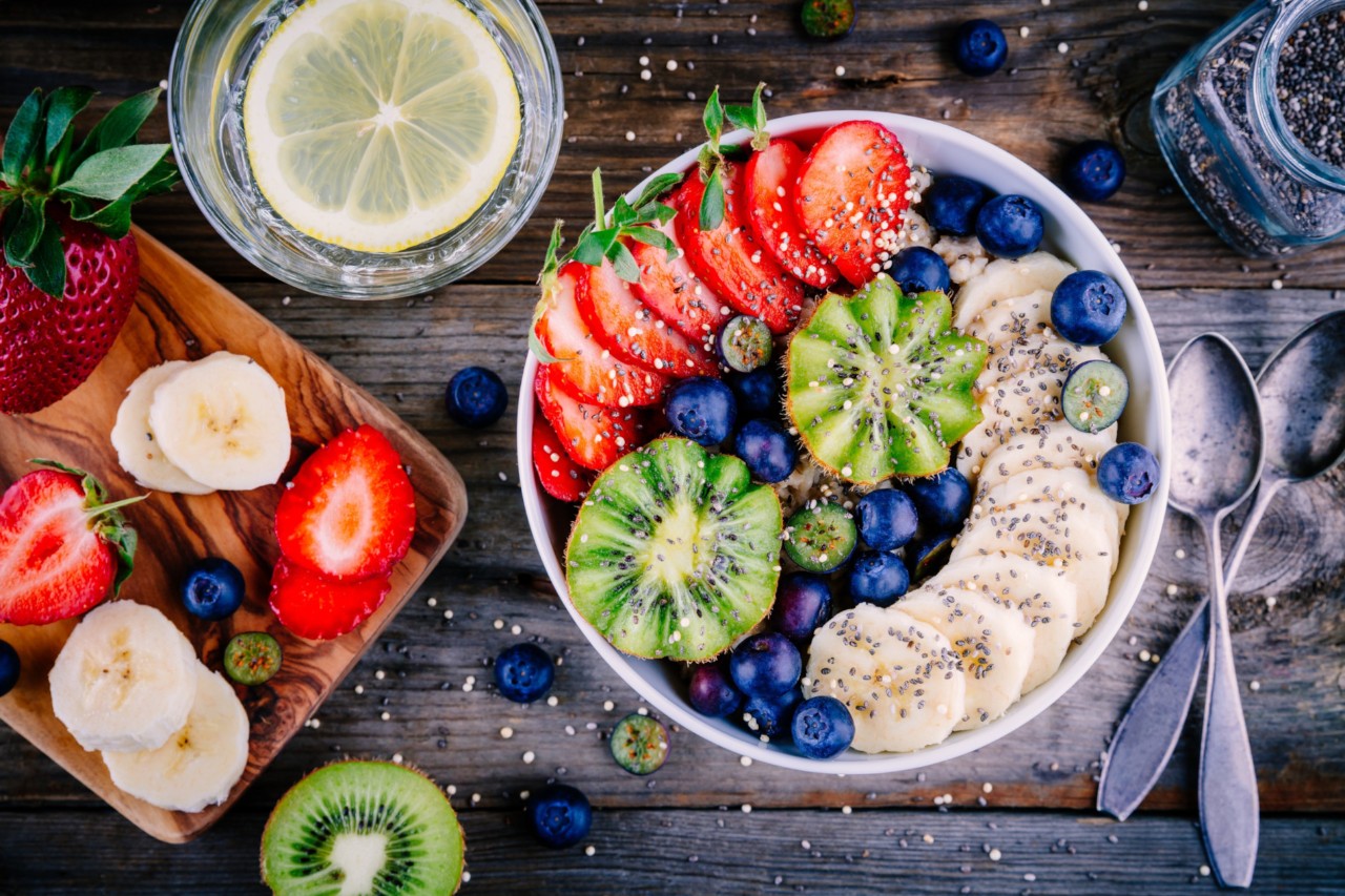 Healthy breakfast bowl: oatmeal with banana, kiwi, strawberry, blueberries and chia seeds